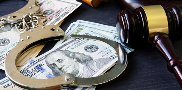 Photo of money, handcuffs and a judge's hammer