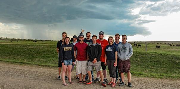 UNC students in front of a storm they chased in May 2019.